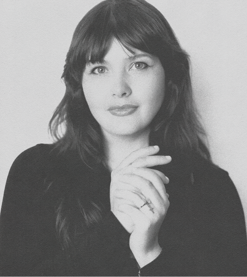 Black and white portrait of a woman, Sam Roberts, with long hair against a plain background